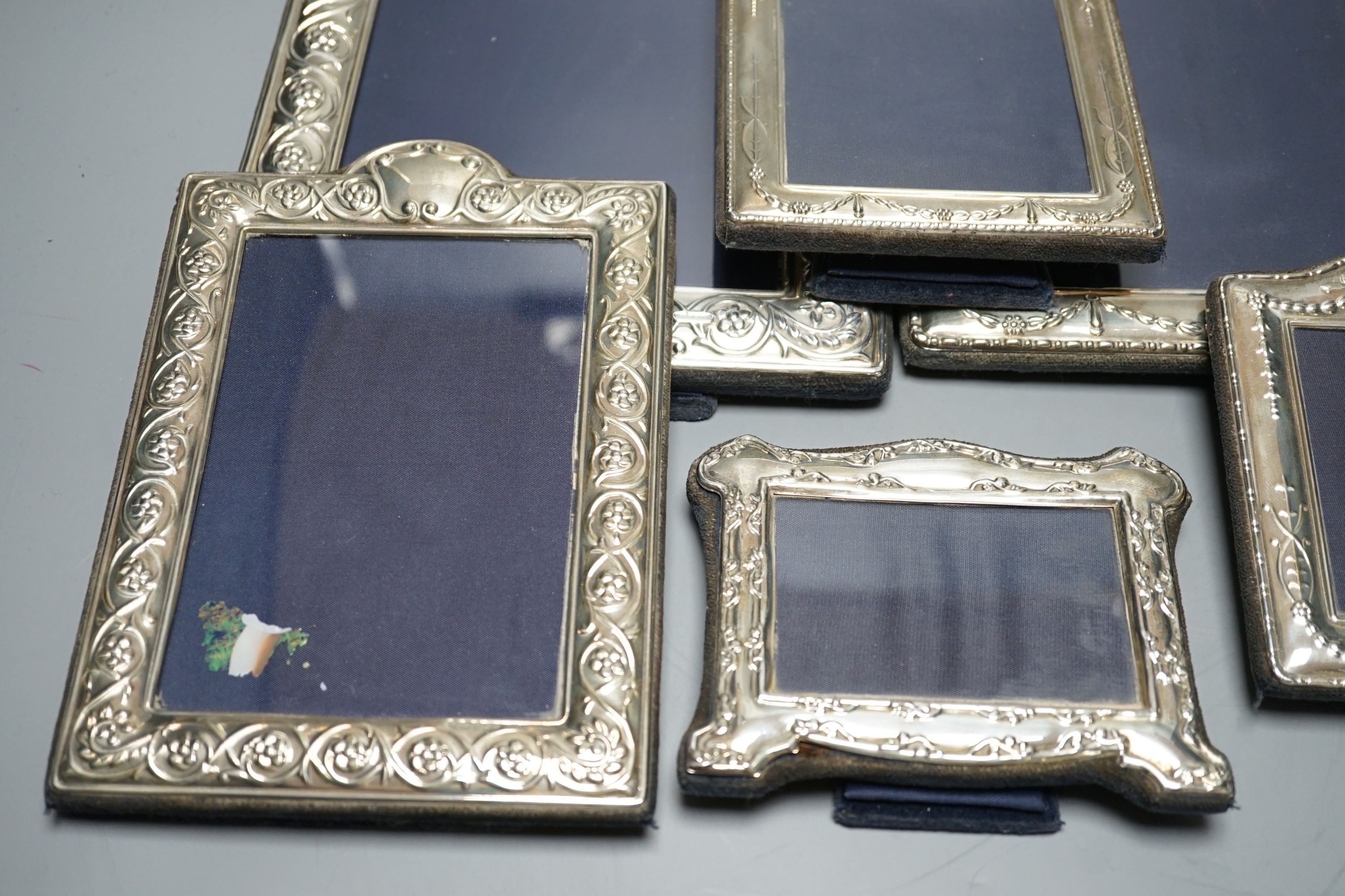Two modern graduated pairs of decorated silver mounted photograph frames, Carrs of Sheffield, 2000 & 2001, largest 25.6cm and two smaller silver mounted frames.